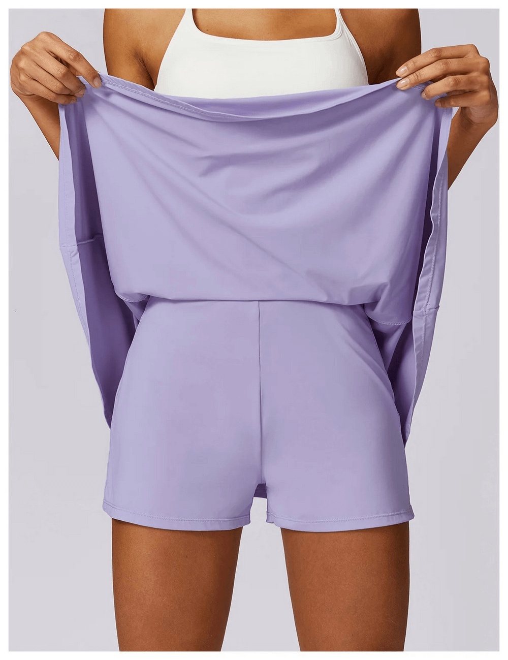 Woman showcasing Stylish Women's Flared Sports Skirt, SF2197, in lavender. Ideal for dance, running, and fitness; blend of nylon and spandex.
